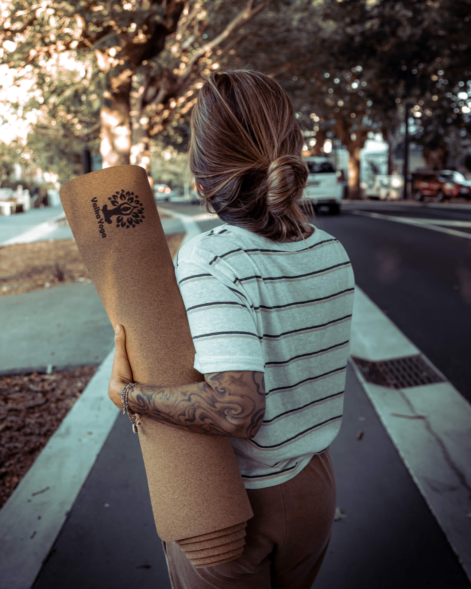 Yogini carrying NZ designed yoga mat