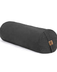 A charcoal grey cylindrical yoga bolster pillow with a small cork logo patch, shown on a clean white background
