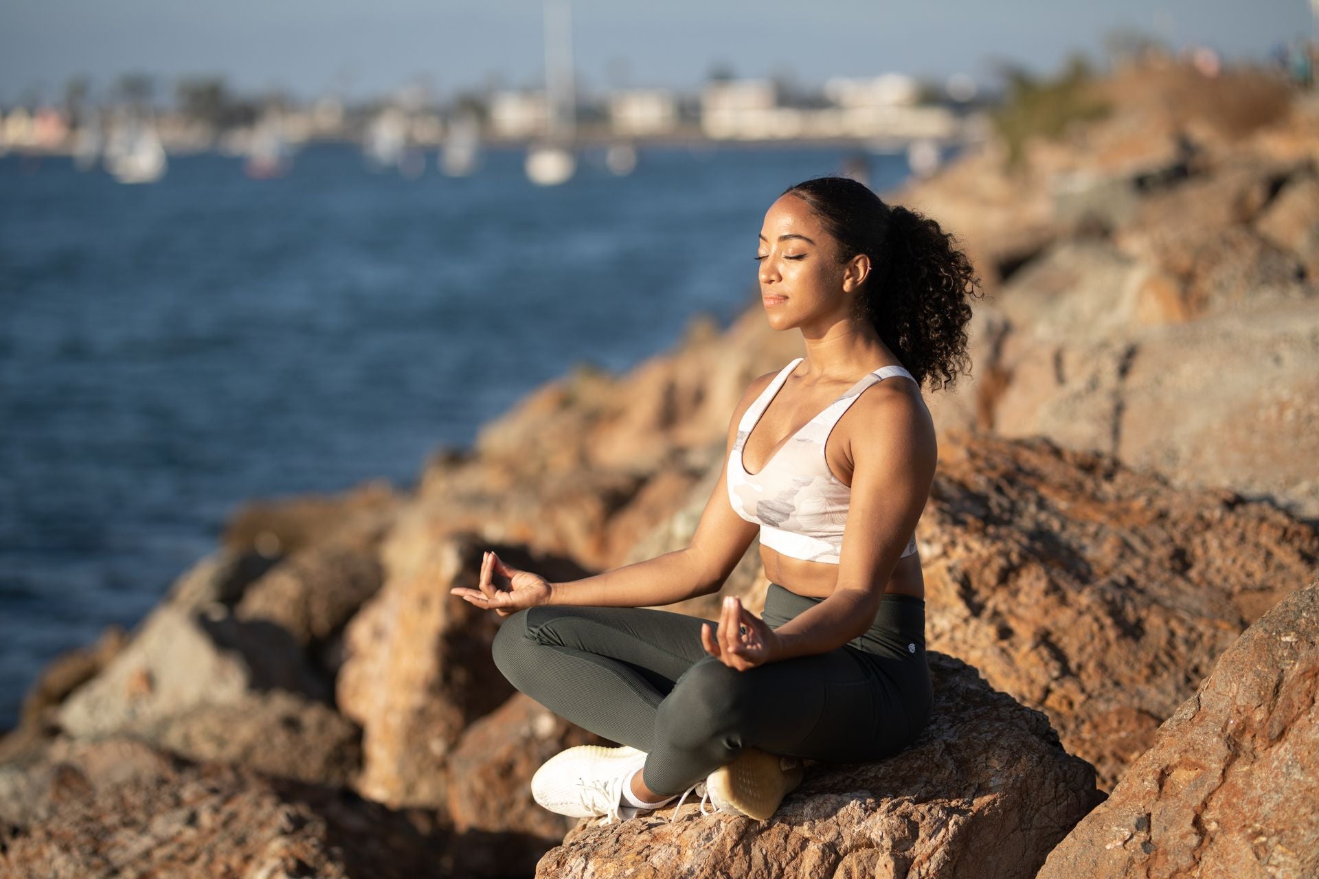 Woman meditating by the sea