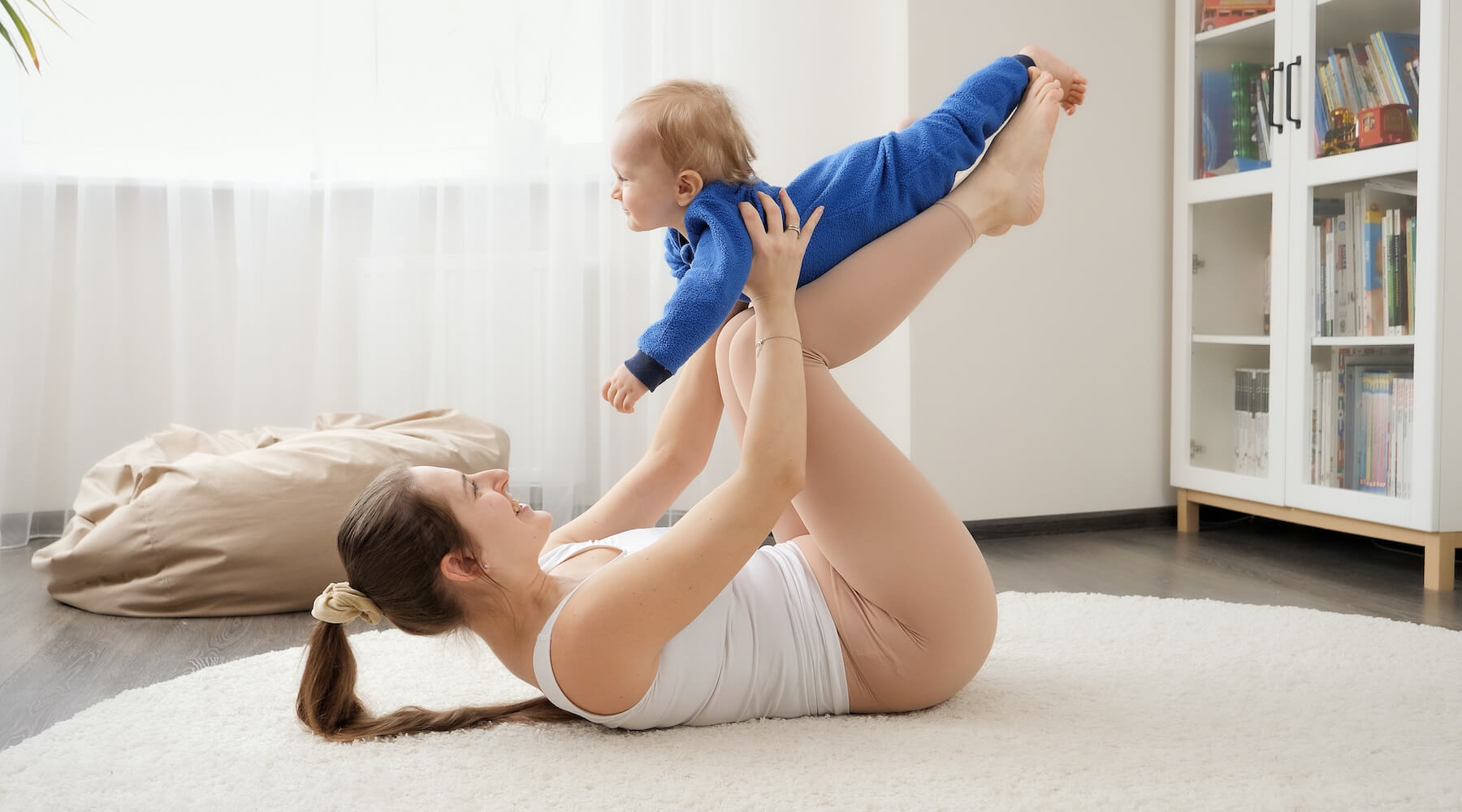 Yoga mom playing with toddler