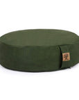 An oval-shaped dark green meditation cushion with a small brown cork tag on the side, photographed against a solid white background