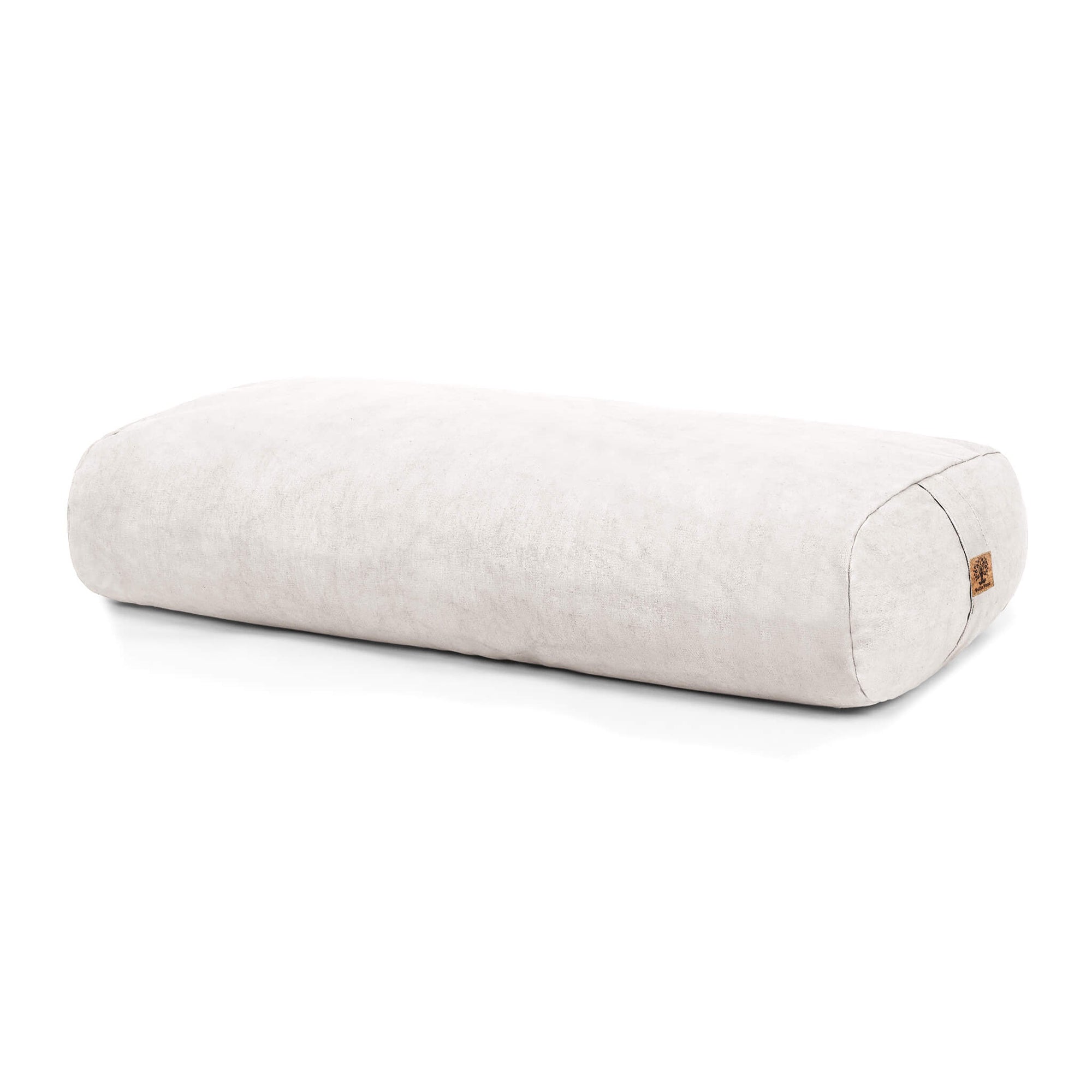 A rectangular bolster in an off white linen-like fabric, shown on a clean white background with a small cork tag on one end