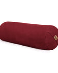 A cylindrical red fabric bolster with a small cork brand tag, shown on a clean white background