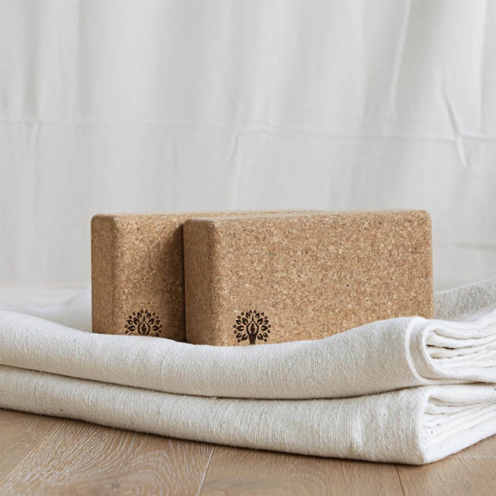 Cork Yoga Bricks on top of white yoga blanket