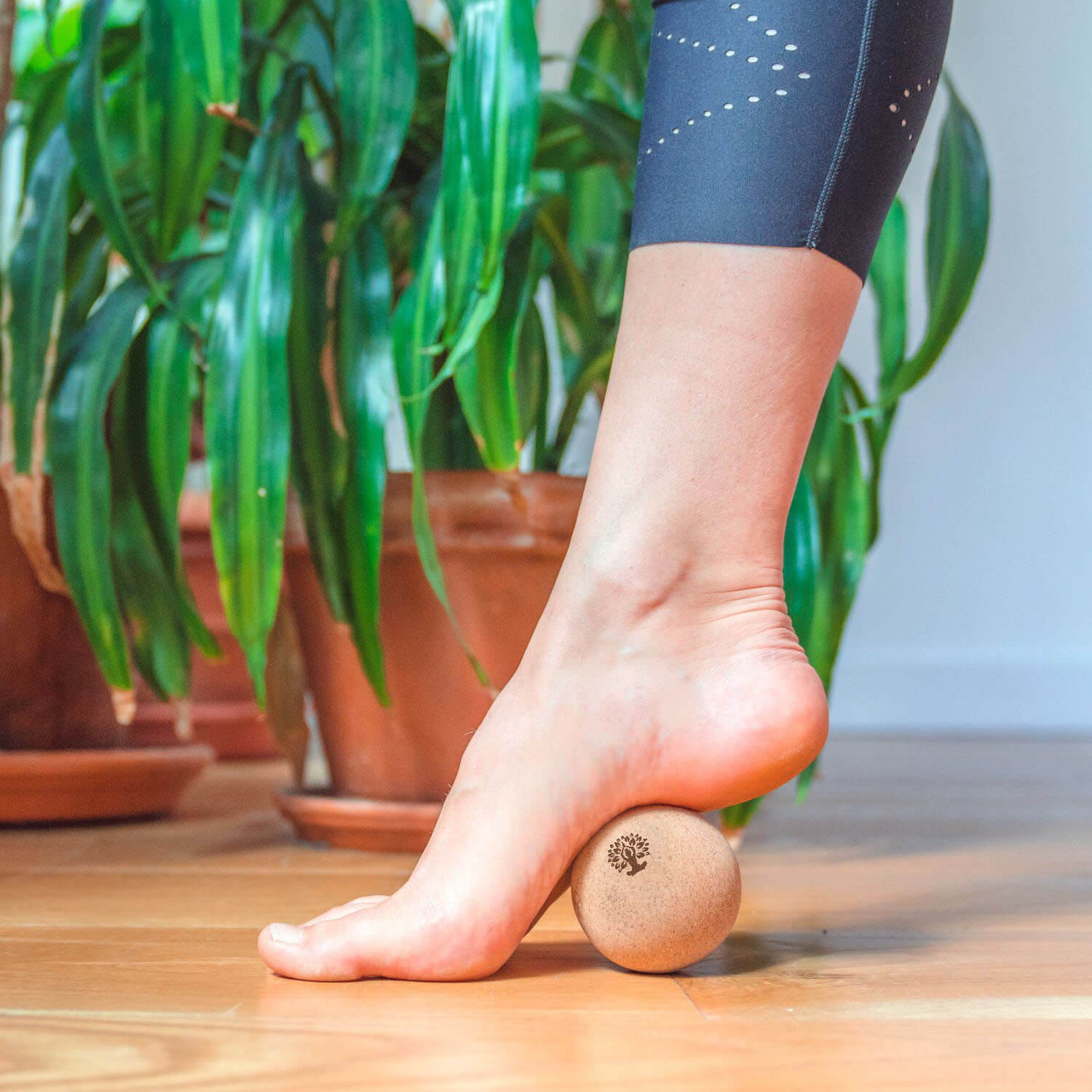 Massaging foot with cork massage ball