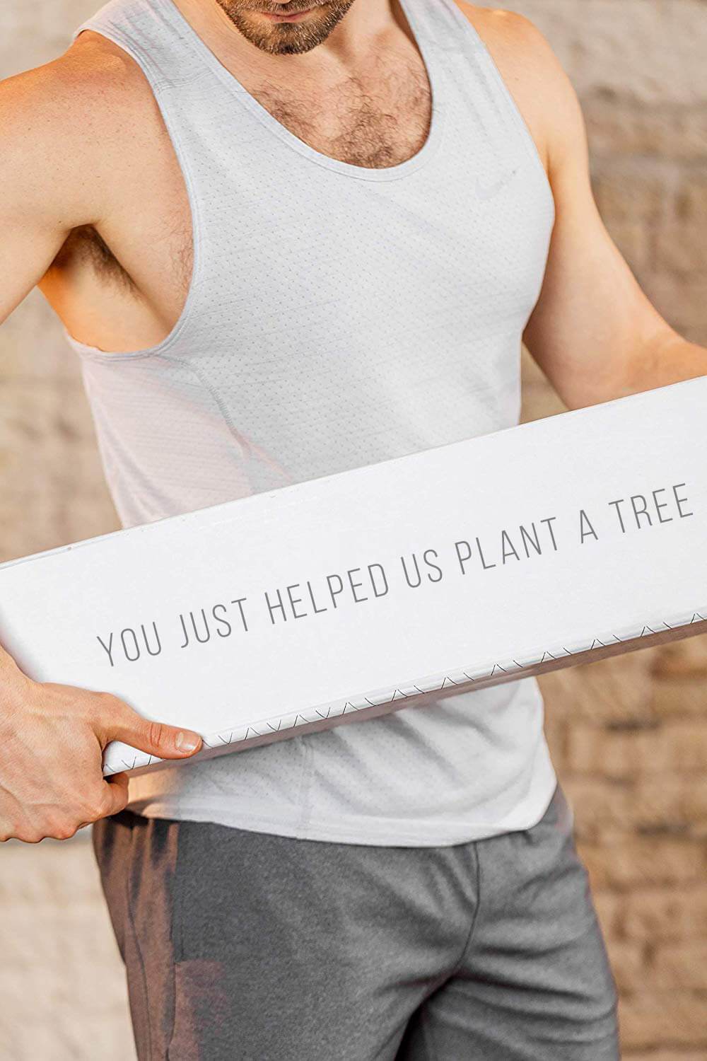 Man holding cork yoga mat box