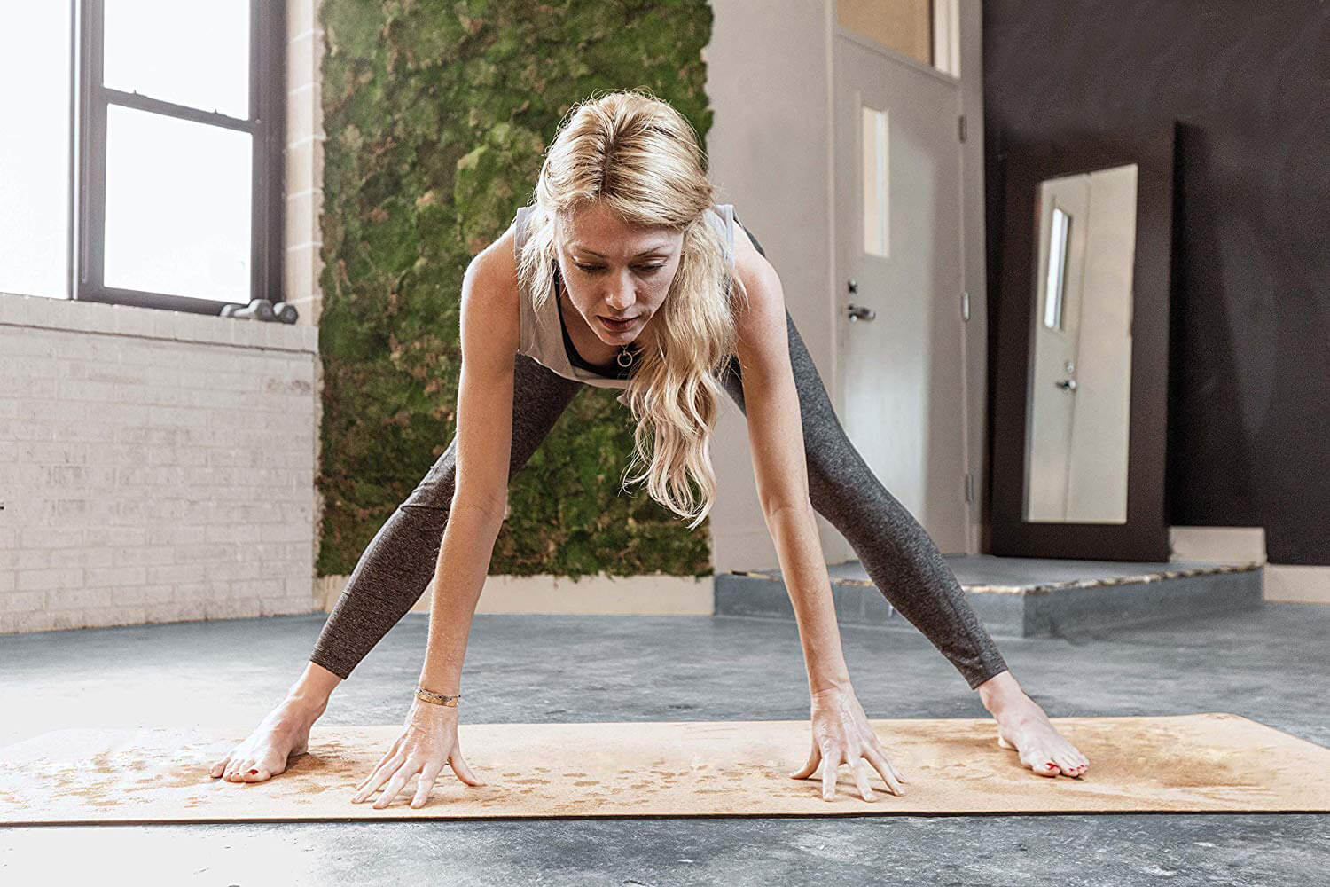Woman practicing on cork yoga mat