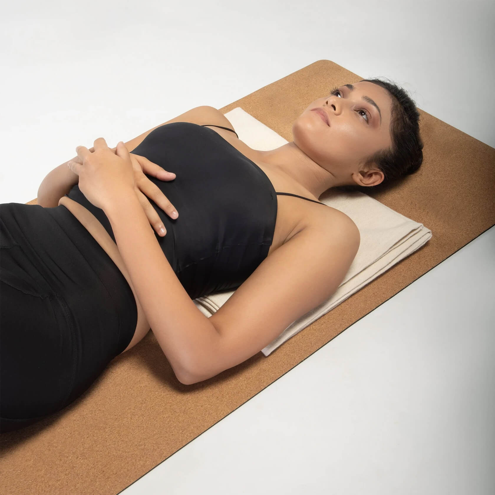 Woman resting on cotton yoga blanket